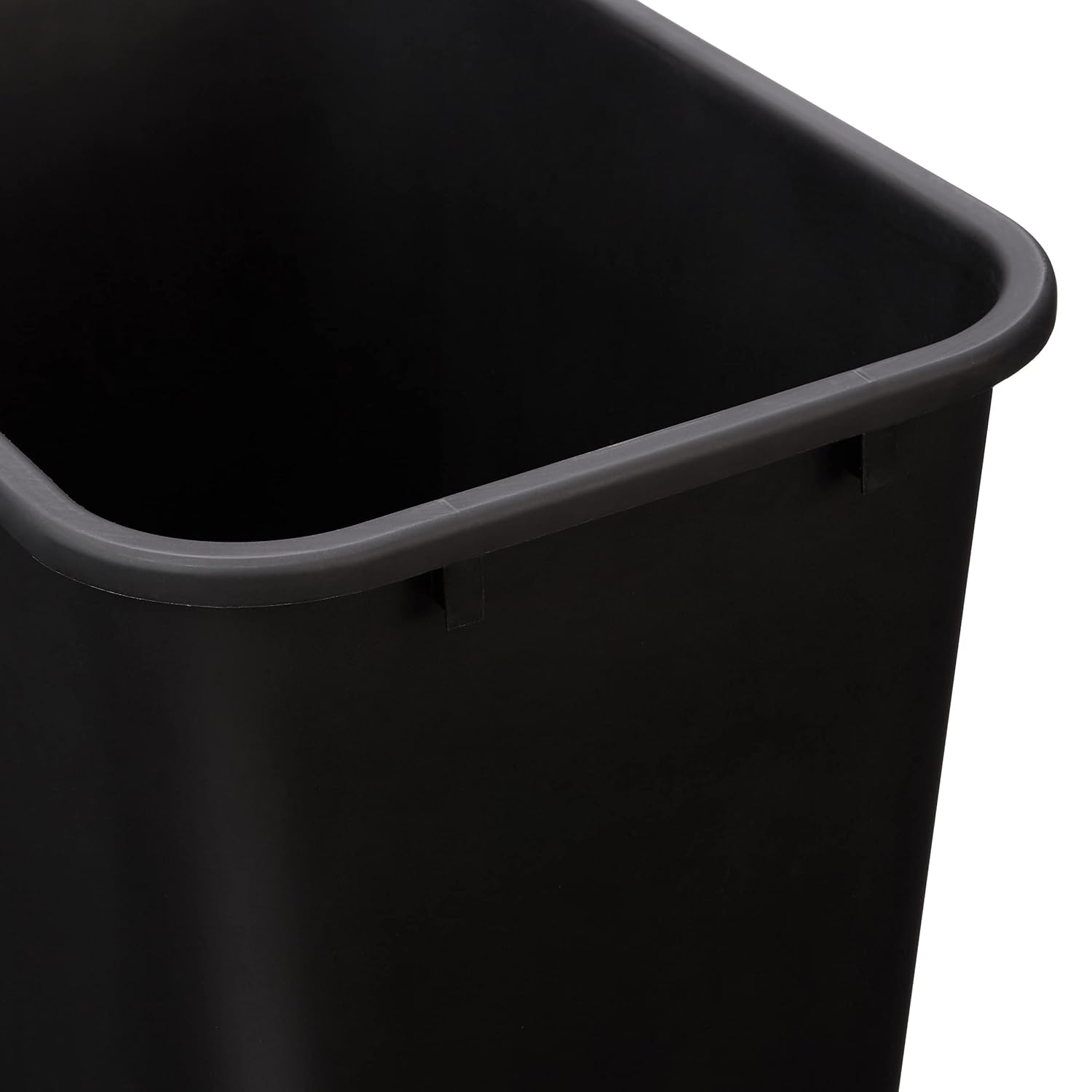 Black space-saving office wastebasket mounted inside a white cabinet door, keeping trash completely hidden.
